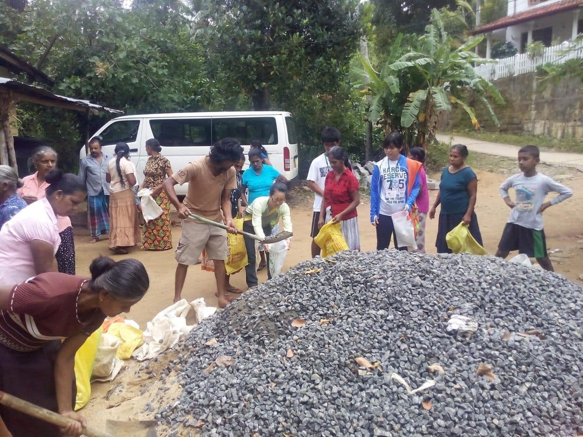 Neighbours turning out to move material for a village construction project.